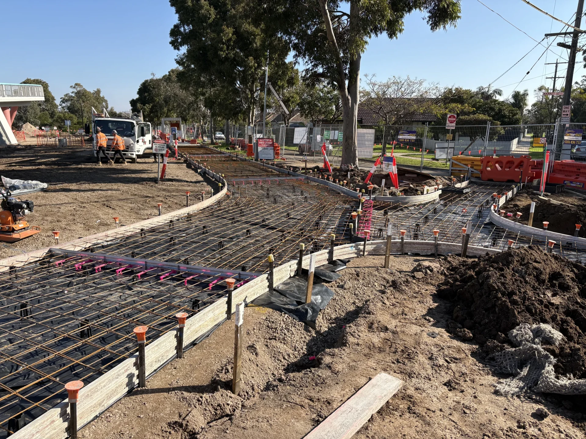 Formwork and steel reinforcement set out for a curved concrete shared-user path pour.